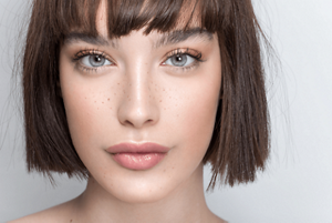 Brunette woman with a short, blunt bob with a fringe